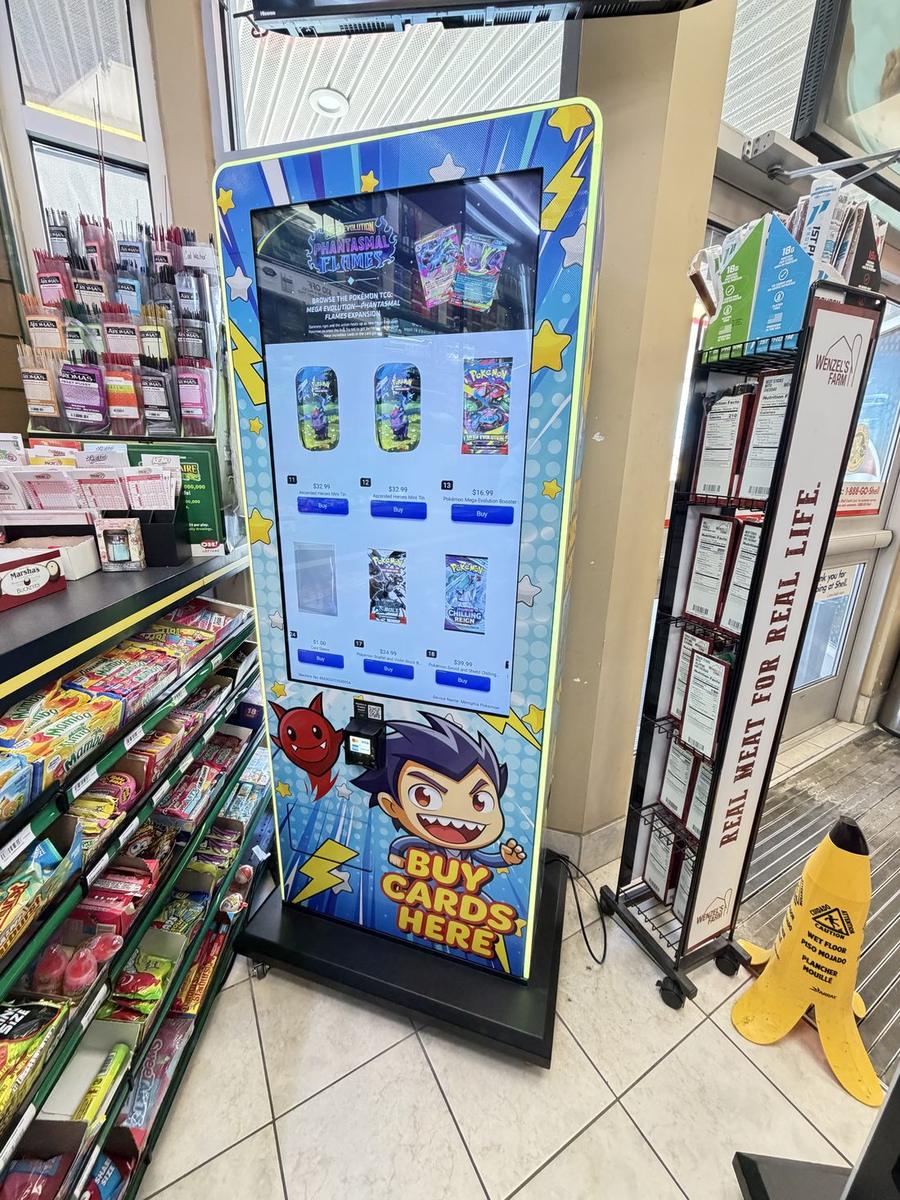 A National Card Vending trading-card machine installed inside a convenience store, with a bright touchscreen and card art wrap